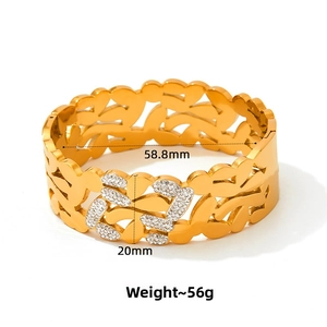 Detail view of wide hollow leaf gold bracelet with white rhinestones and 58.8mm diameter