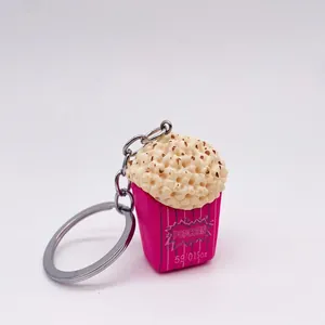 Macro detail of simulation popcorn keychain with pink box and silver metal ring