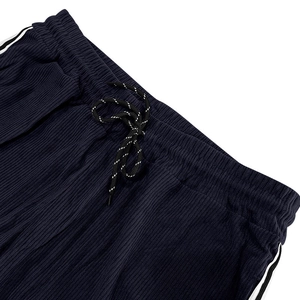 Close-up of elastic waistband and drawstring on navy blue corduroy striped pants
