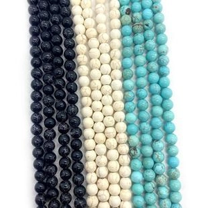 Detailed view of 6-10mm smooth round beads in black, white marble, and turquoise colors