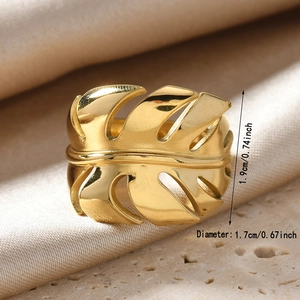 Macro view of adjustable monstera leaf ring in polished gold finish showing dimensions
