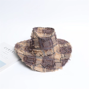 Detail of patchwork denim cowboy hat with frayed edges and decorative cross-stitch