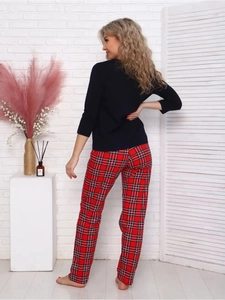 Detail view of women's loungewear set featuring navy top and red plaid pants from behind