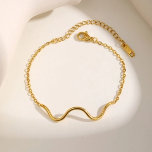 Elegant gold wavy stainless steel bracelet for women with 18K gold plating and lobster clasp