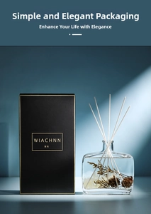 Detail of preserved floral reed diffuser with pine cones in glass bottle and black gift box