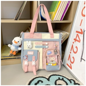 Close-up of pastel color-block backpack with cute charms and transparent pocket details