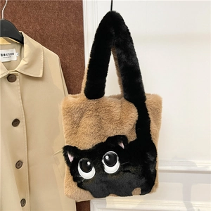 Detail of plush handbag showing black cat design with large eyes and furry texture