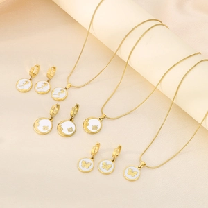 Detailed set of gold-plated necklaces and earrings featuring rose and butterfly patterns