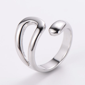 Macro detail of polished stainless steel infinity ring with elegant curved lines
