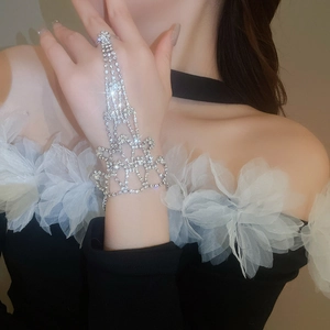 Close-up of a sparkling rhinestone finger bracelet with floral lace design for parties