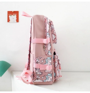 Side view of pink nylon school bag with unicorn patterns and adjustable straps