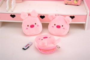 Detail of pink plush pig coin purse with soft texture and delicate embroidery