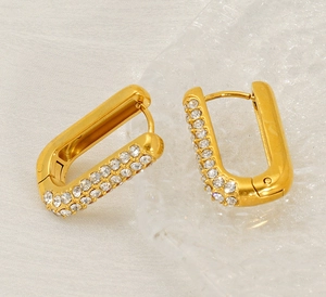 Close-up of gold-plated rectangular hoop earrings with double-row micro-pave zircons