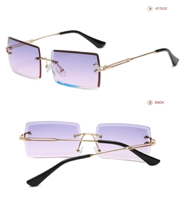 Detail view of rimless rectangle sunglasses with purple gradient lenses and gold metal frames