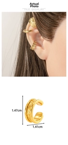 Detail view of vintage gold ear cuff featuring ornate European engraved vine patterns