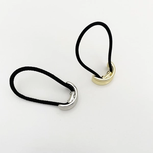 Close-up of minimalist gold and silver alloy metal buckles on high elastic hair ties
