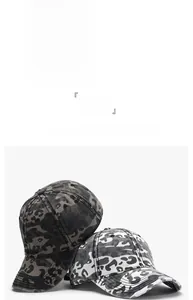 Detailed display of camouflage baseball caps in rose red, charcoal, and monochrome patterns