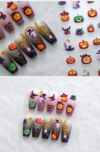 Detail of Halloween nail stickers with pumpkins and ghosts on gradient matte nails