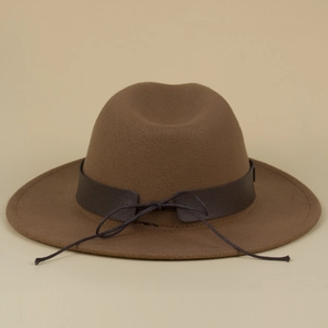 Detail of brown wide brim fedora with vintage leather band and decorative knot