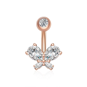 Macro shot of rose gold butterfly belly button ring with sparkling zircon and reflection
