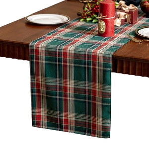 Classic Christmas tartan table runner in red and green cotton linen on a wooden table