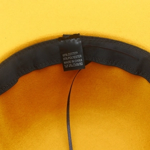 Detail view of cotton blend inner lining and wash care label for leopard wool fedora