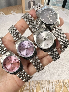 Detailed display of slim women watches with metal straps in pink, purple, silver and grey
