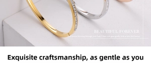 Macro shot of minimalist gold and silver bangles with pavé zircon stones on white steps