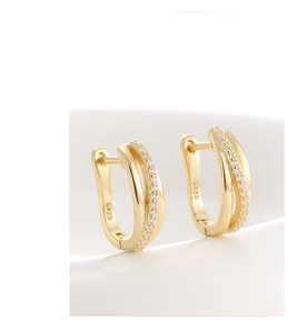 Macro detail of gold plated S925 silver earrings with pavé cubic zirconia stones