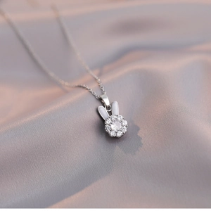 Elegant rotating rabbit pendant necklace in silver with sparkling zircon and white enamel