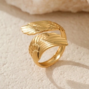 Close-up of a 18k gold plated stainless steel ring with an open double wing design