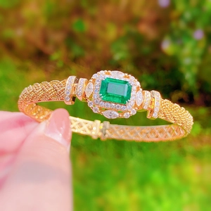 Italian vintage woven gold bracelet with emerald gemstone and sparkling diamonds