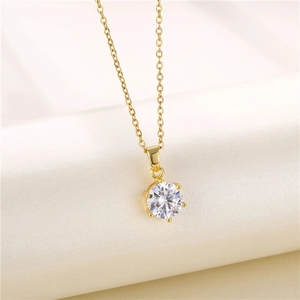 Macro shot of 18K gold plated necklace featuring a classic six-prong round zircon pendant