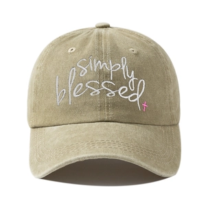 Detail of embroidered Simply Blessed text and pink cross on khaki washed cotton cap
