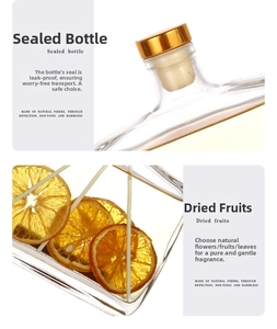 Macro detail of squared glass diffuser bottle with dried orange slices and gold cap