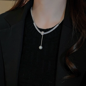 Dettaglio della collana a Y in argento con zirconi lucenti e una perla rotonda pendente