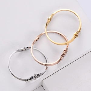 Three-color minimalist bangles with sparkling rhinestones on textured stone display