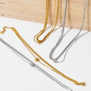 Double-layered gold and silver flat snake chain necklaces with polished round bead charms