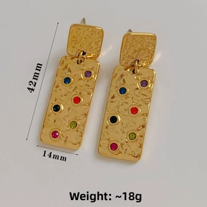 Detail view of gold rectangle earrings with colorful gems and hammered texture, 42mm size