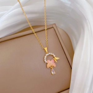 Golden titanium necklace featuring a pink butterfly pendant with pearls and zircon drop