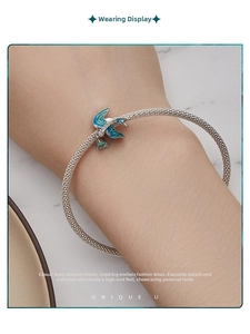 Mesh silver bracelet featuring a blue enamel swallow bird charm with sparkling crystals