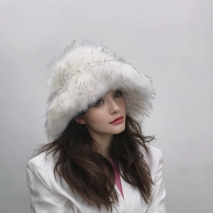 Close-up of white faux fur winter bucket hat with black tips worn by a model