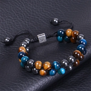 Detail of 8mm tiger eye stone beads and Tree of Life charm on double-layer woven bracelet
