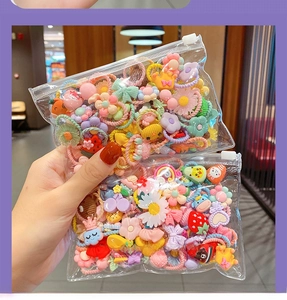 Close-up of colorful assorted elastic hair ties in bulk packaging for children
