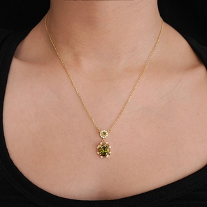 Close-up of 18K gold plated double pendant necklace with green oval zircon on model skin
