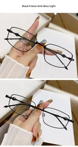 Detailed view of black metal frame glasses with unique geometric wavy temple design