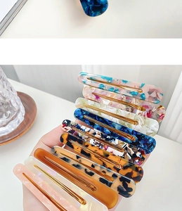Set of eight assorted acetate hair clips with leopard print and floral patterns