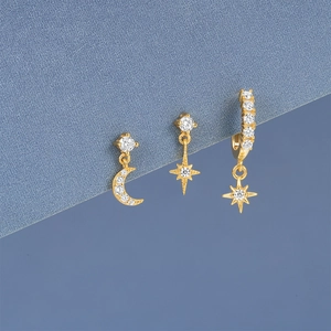 Detailed macro view of S925 silver moon and star earrings set with cubic zirconia stones