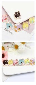 Detailed macro shot of diverse milk carton enamel pins featuring creative graphic patterns