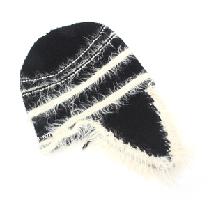 Detail of knit aviator hat with plush faux fur lining and woven brand label